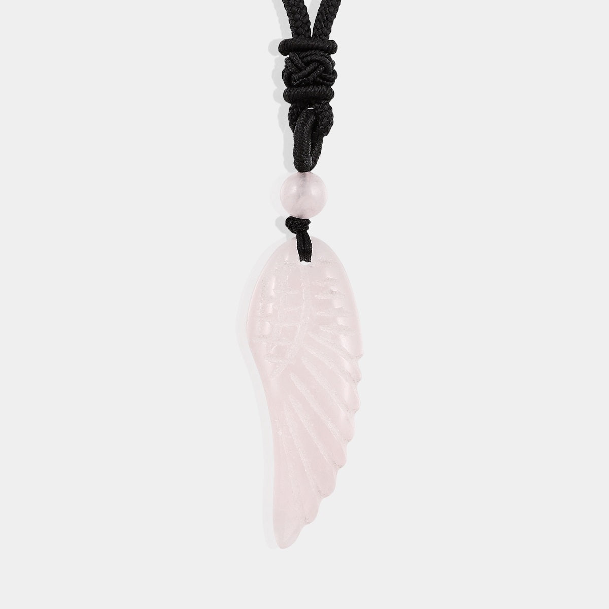 Exquisite carved wing pendant made of rose quartz