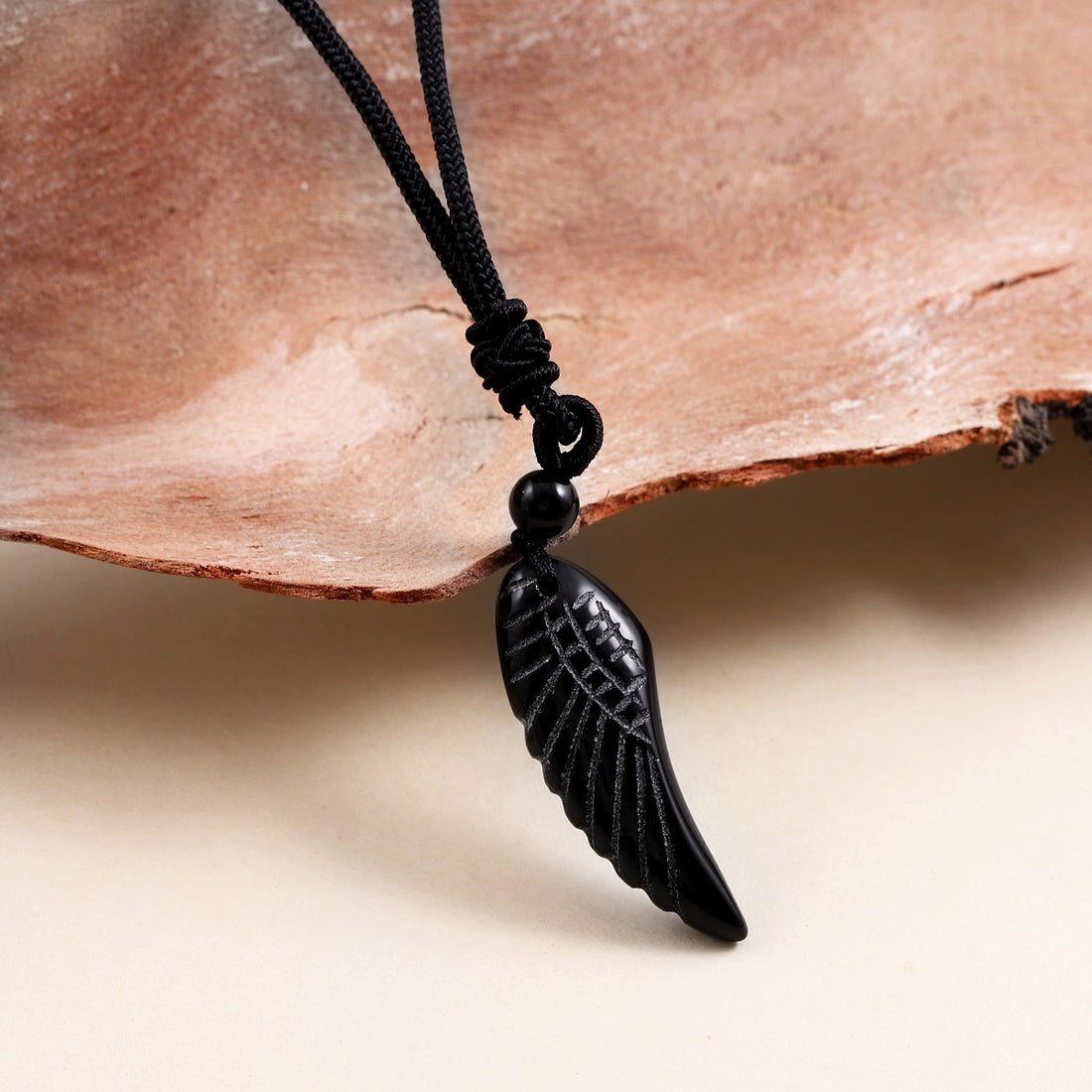Pendant wrapped necklace featuring a black onyx gemstone.