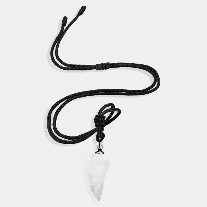 A close-up view of the pendant necklace showcasing the smooth fang tooth pendant wrapped with an adjustable rope necklace, featuring a stunning white quartz gemstone.