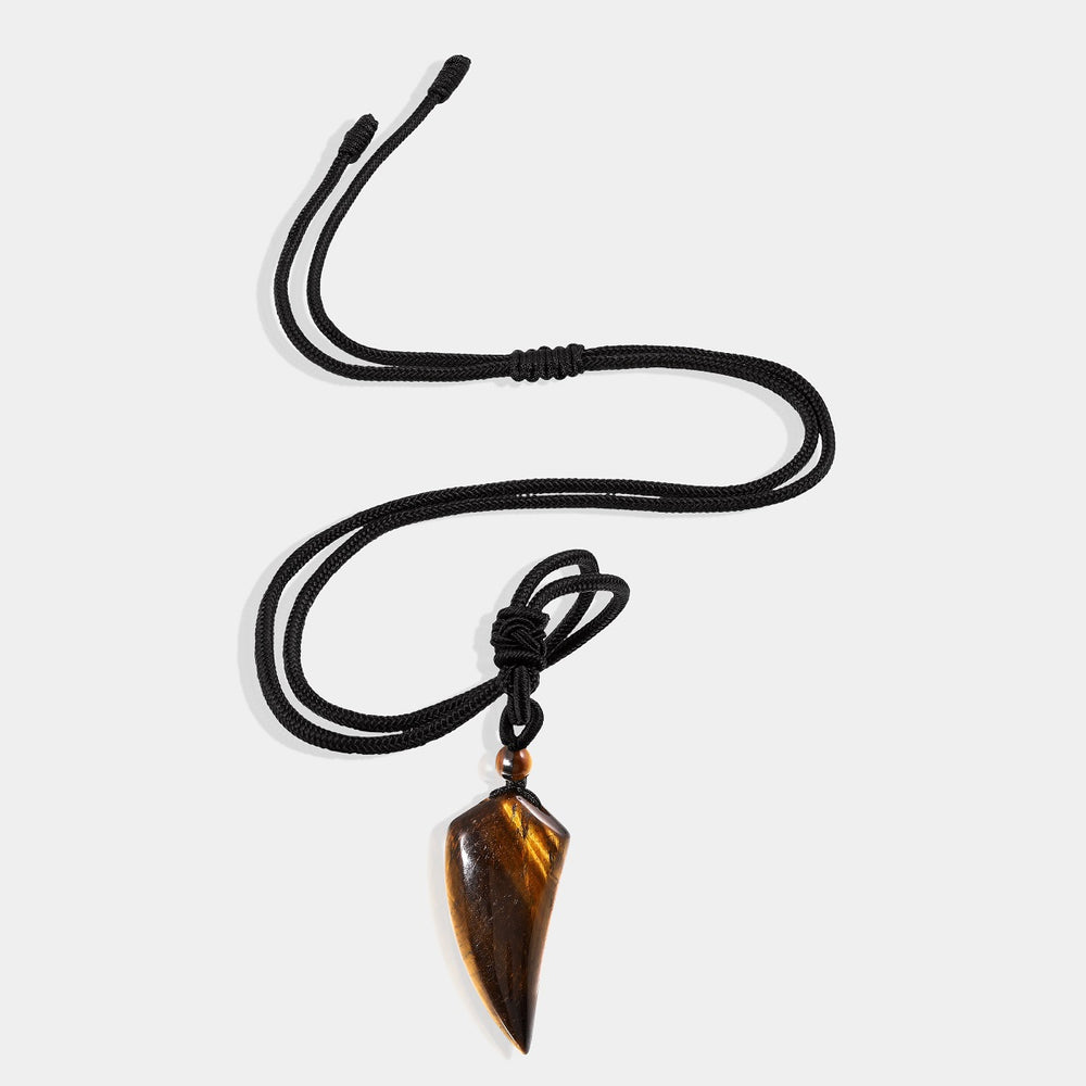 A close-up view of the pendant necklace showcasing the smooth fang tooth pendant wrapped with an adjustable rope necklace, featuring a mesmerizing tiger's eye gemstone.