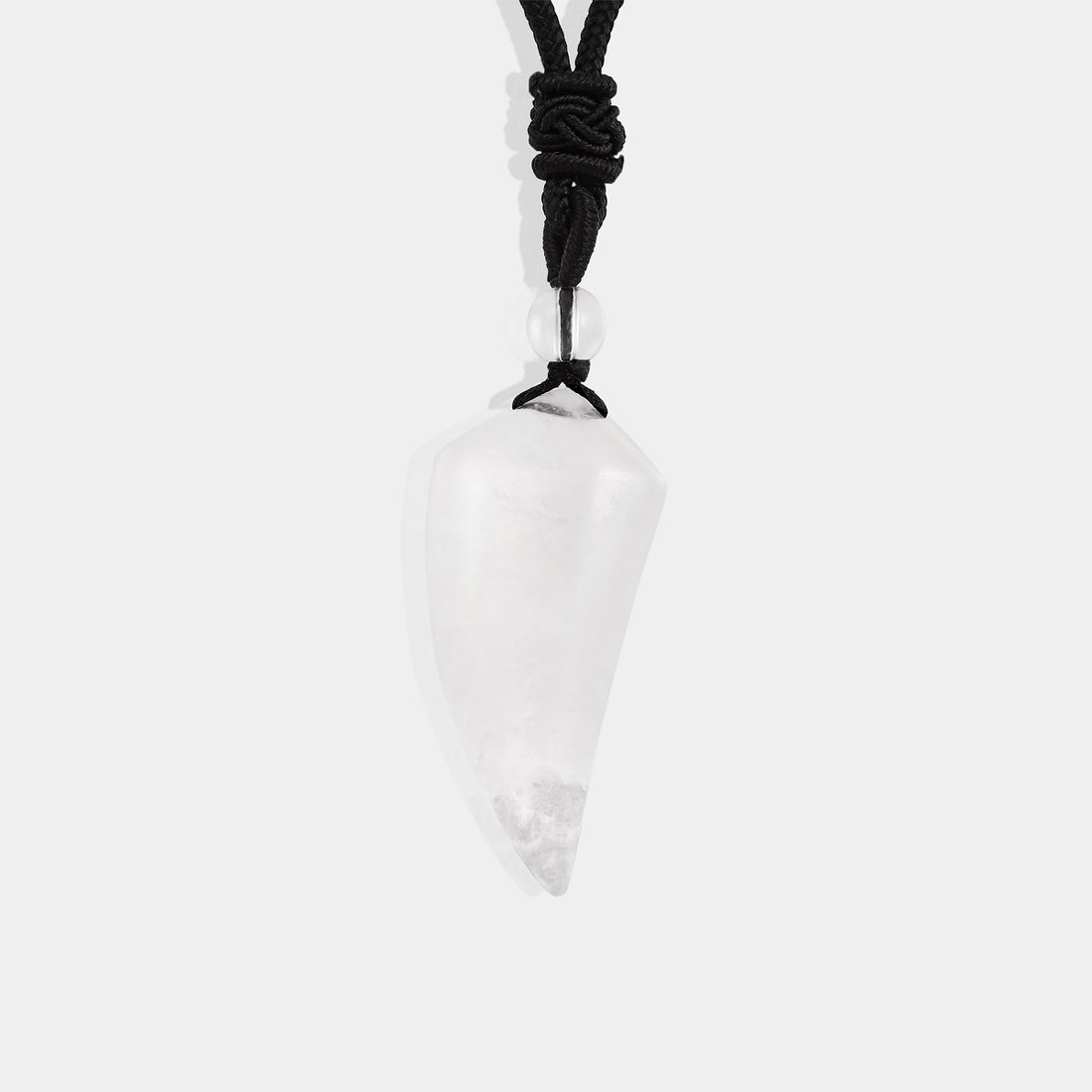 A close-up view of the pendant necklace showcasing the smooth fang tooth pendant wrapped with an adjustable rope necklace, featuring a stunning white quartz gemstone.