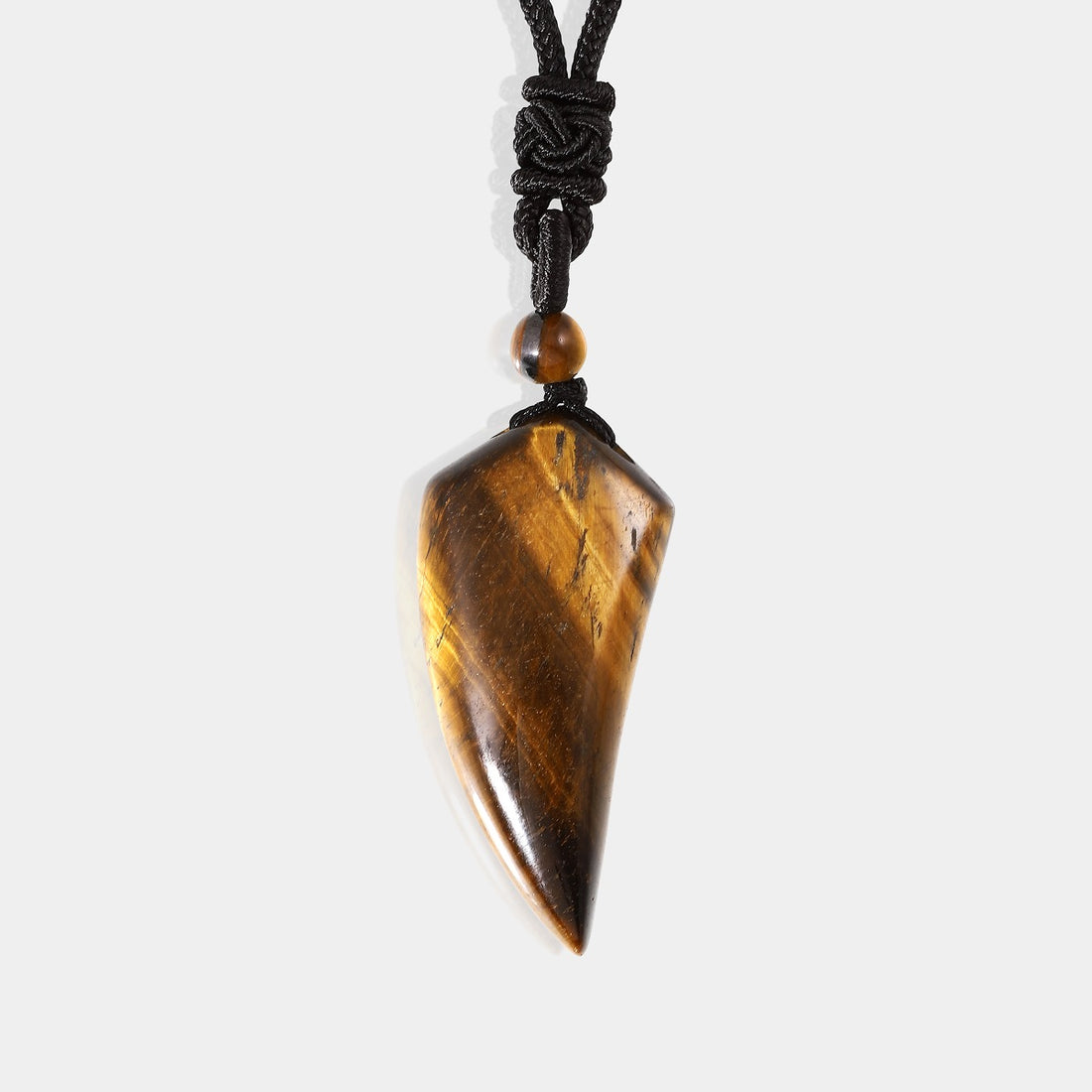 A close-up view of the pendant necklace showcasing the smooth fang tooth pendant wrapped with an adjustable rope necklace, featuring a mesmerizing tiger's eye gemstone.