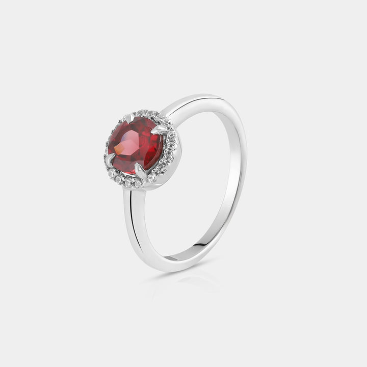 Side angle view capturing the intricate details of the Halo Ring. The halo of 18 round Zircon accents, each measuring 1.25mm, adds a radiant brilliance to the central Garnet