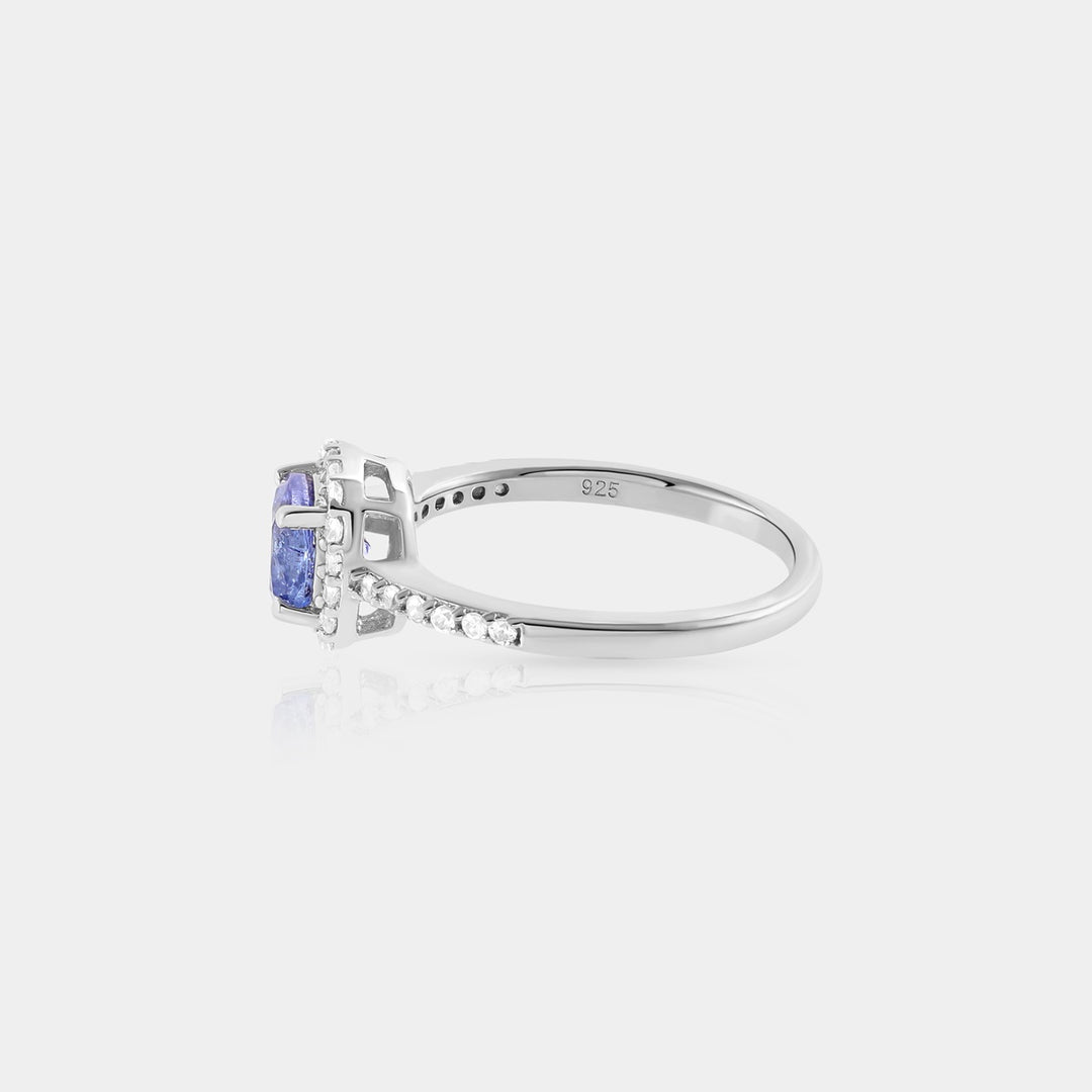 The 925 Silver Ring, highlighting the exquisite craftsmanship and the prong setting that secures the Tanzanite and Zircon gemstones in a solitaire with accents design.