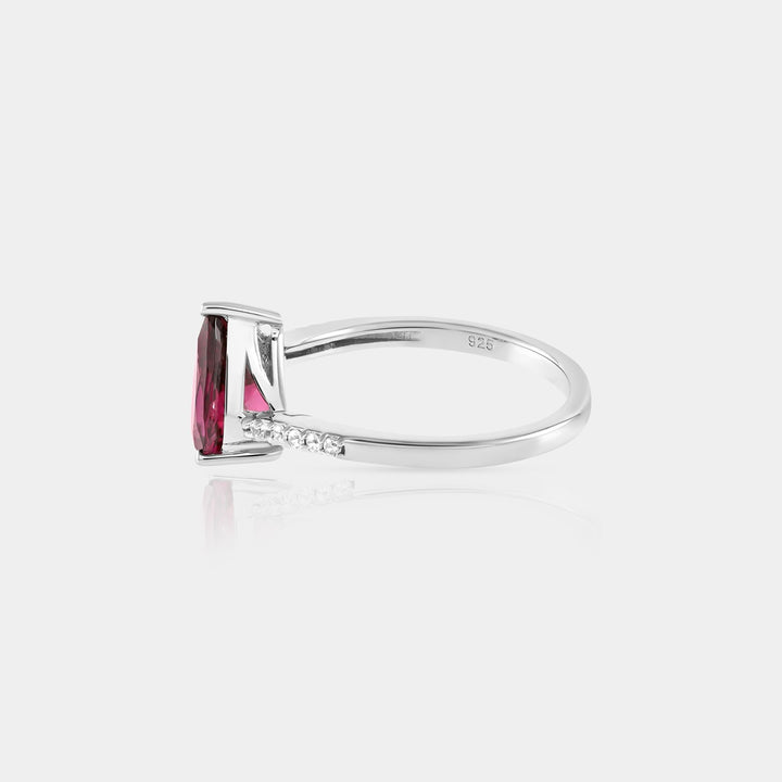 A captivating presentation of the Solitaire with Accents Ring, displaying the harmonious blend of the Purple Garnet and Zircon accents, a perfect statement piece