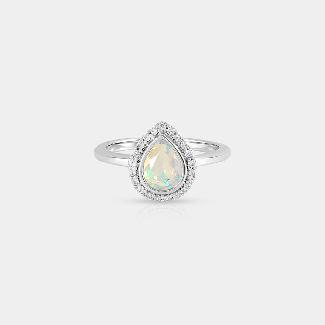 A captivating top-down view of the Ethiopian Opal & Zircon Halo Ring, showcasing the pear-shaped Opal and the surrounding halo of sparkling Zircon stones.