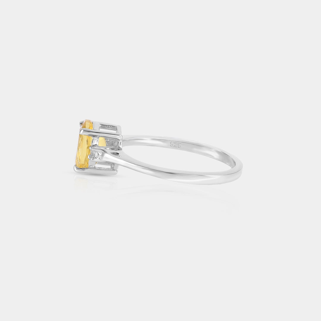 Side profile image emphasizing the meticulous prong setting of the 6 x 8 mm Oval-cut Yellow Fluorite gemstone, showcasing its depth and brilliance