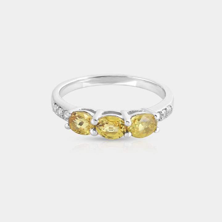 Close-up view of the vibrant 4x5mm oval Yellow Sapphire, showcasing its rich yellow hue and intricate facets