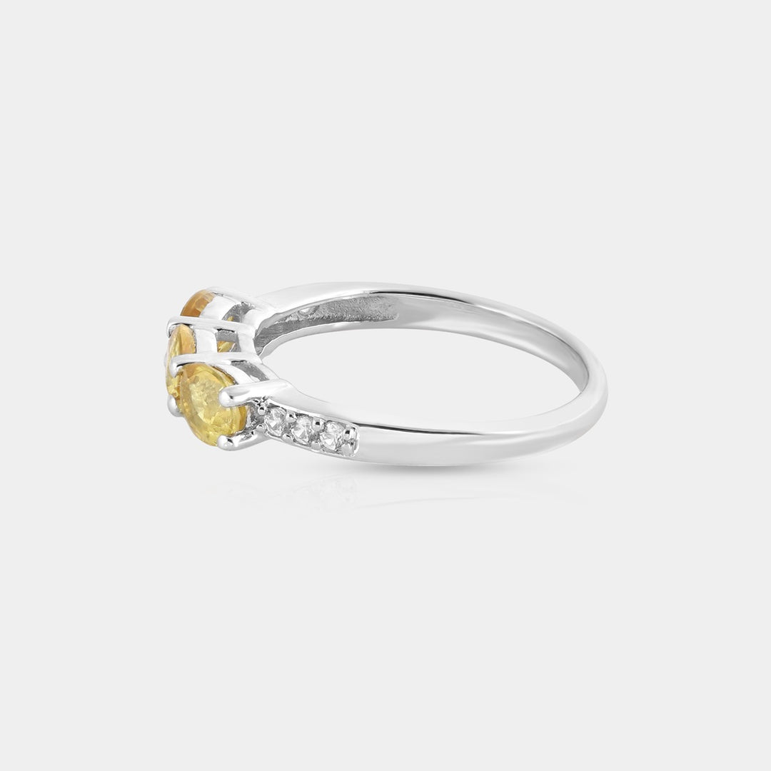 Detailed shot of the 1.5mm round Clear Zircon accents, elegantly prong-set around the Yellow Sapphire, adding a touch of sparkle