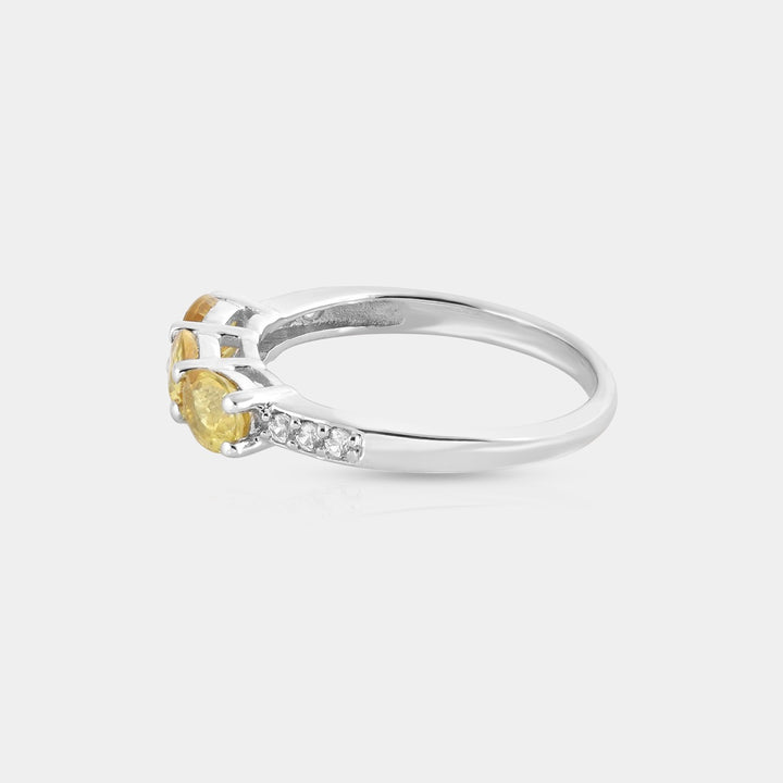 Detailed shot of the 1.5mm round Clear Zircon accents, elegantly prong-set around the Yellow Sapphire, adding a touch of sparkle