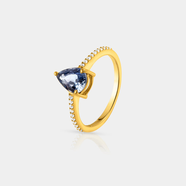 Side angle view capturing the intricate details of the Solitaire with Accents Ring. The 20 round Zircon accents, each measuring 1.1mm, enhance the brilliance of the central Blue Sapphire.