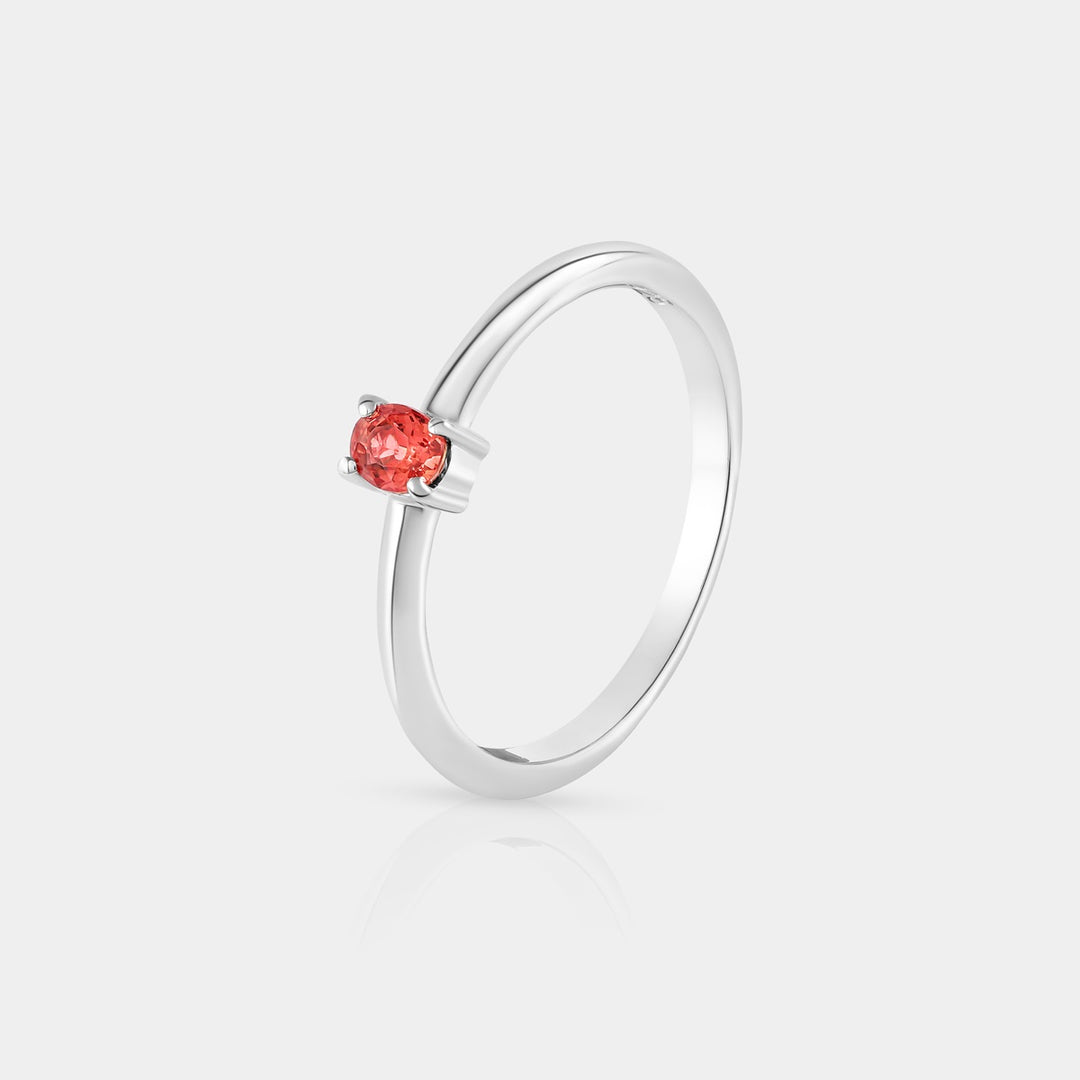 Side profile image emphasizing the intricate prong setting of the 3 x 4 mm Oval-cut Sunset Sapphire gemstone, showcasing its depth and brilliance.