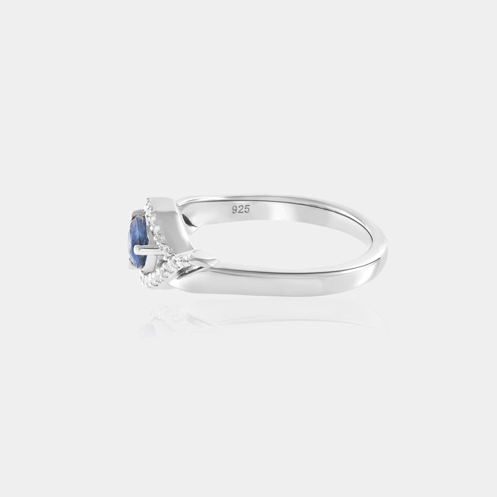 Inspiration shot featuring the Blue Sapphire & Zircon Halo Ring, elegantly styled for evening wear, showcasing its versatility and timeless allure