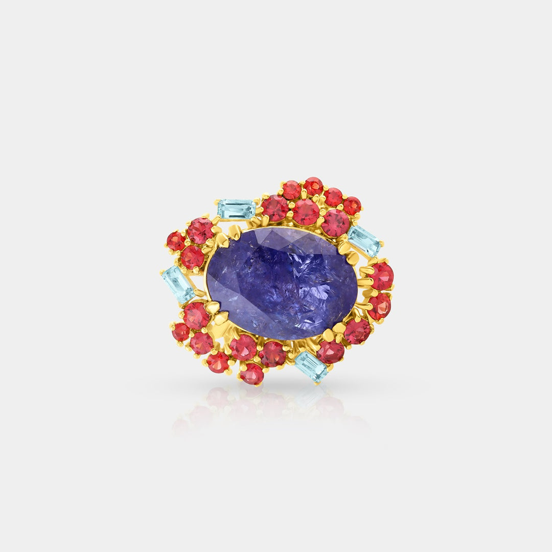 Detailed shot featuring the prong-set Baguette-cut Blue Topaz Swiss stones, adding a burst of vibrant blue color and precision to the ring's design.