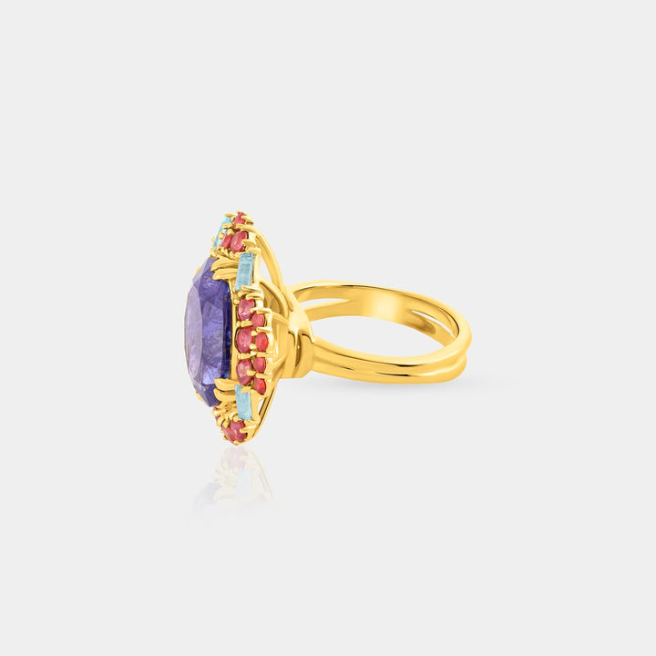 Side angle image highlighting the meticulous prong settings of the Blue Topaz Swiss and Ruby Tanzanian stones, enhancing the ring's overall brilliance." Gemstone Close-Up: