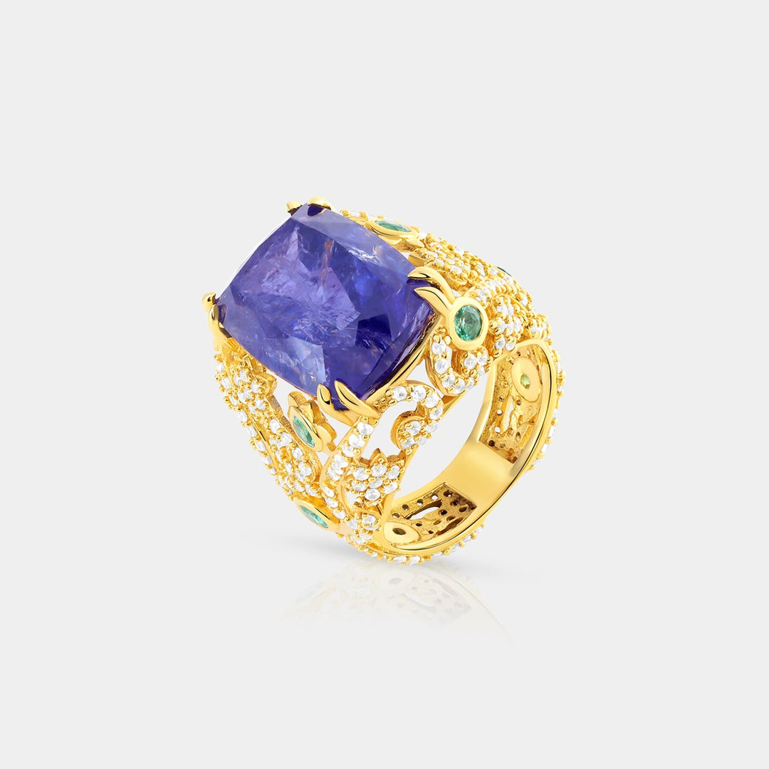 Overhead view showcasing the 12x16 mm Cushion-cut Natural Tanzanite in prong setting, surrounded by vibrant Emerald Russian and White Zircon