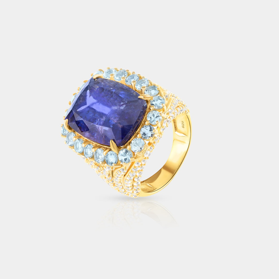 Overhead view showcasing the 13x18 mm Cushion-cut Natural Tanzanite in prong setting, surrounded by vibrant Aquamarine Santa Maria and White Zircon